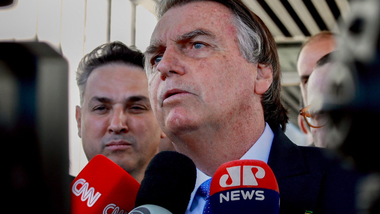 Brazilian former President Jair Bolsonaro speaks to the press as he leaves the Federal Senate in Brasilia on June 21, 2023. Former far-right president Jair Bolsonaro faces a trial starting Thursday that could disqualify him from holding public office for eight years and leave him out of the 2026 Brazilian elections. The Superior Electoral Tribunal (TSE) begins to decide on an open case against the former president (2019-2022) for attacks against the electoral system of electronic ballot boxes during a meeting with diplomats in July 2022, three months before the presidential elections in which he was defeated by the leftist Luiz Inacio Lula da Silva. (Photo by EVARISTO SA / AFP)