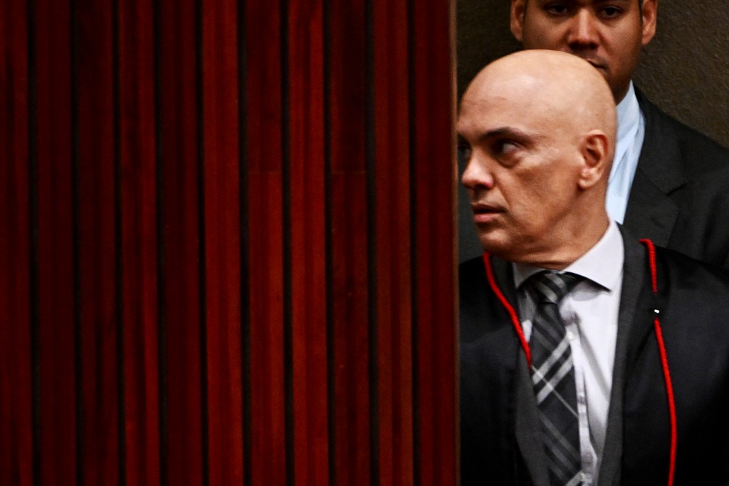 Superior Electoral Court President, Alexandre de Moraes, gestures on his arrival to the court before the beginning of the trial of Brazilian former President Jair Bolsonaro, accused of abuse of power and misinformation, in Brasilia on June 22, 2023. Brazil's electoral court began delivering its ruling Thursday on charges ex-president Jair Bolsonaro broke the law with his unproven allegations against the voting system, a case that could eliminate him from the 2026 presidential race. The Superior Electoral Tribunal (TSE) is trying the far-right former president on charges he abused his office and misused state media when, in July 2022 -- three months from elections he would go on to lose -- he convened foreign diplomats for a meeting at which he insisted Brazil's electronic voting machines were susceptible to large-scale fraud. (Photo by EVARISTO SA / AFP)