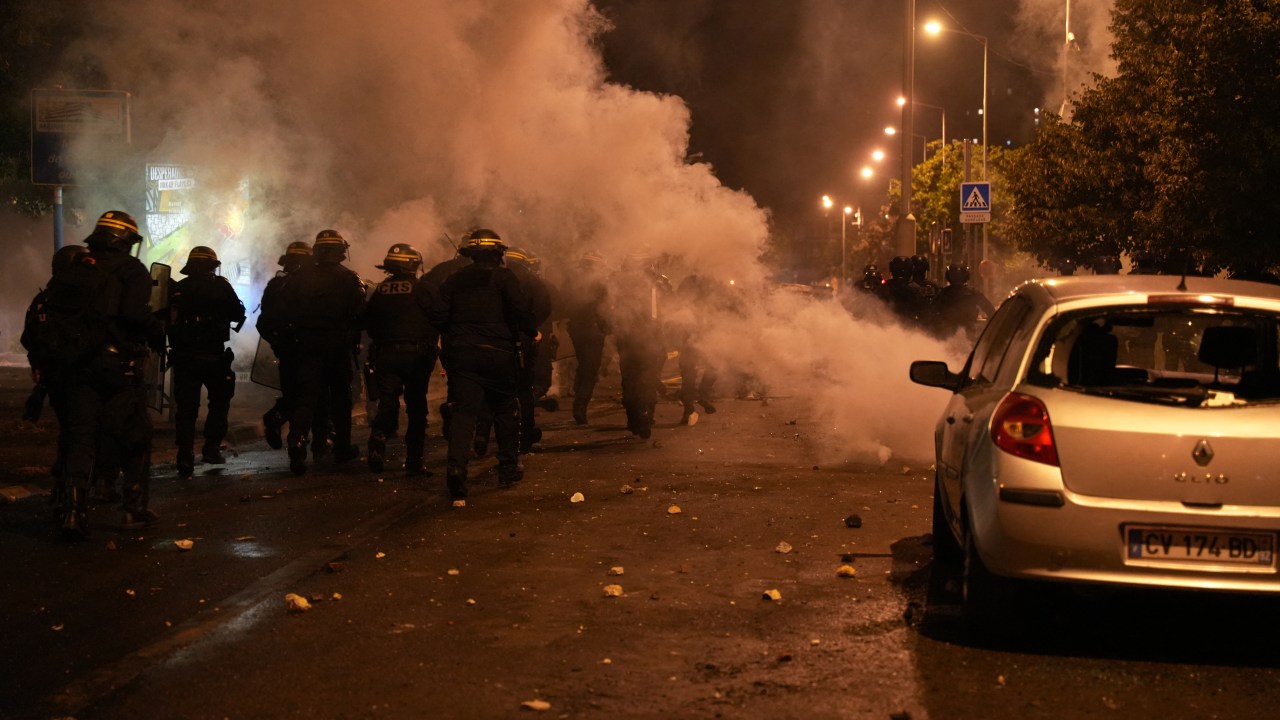 Riot police gather during protests in Nanterre, west of Paris, on June 28, 2023, a day after a 17-year-old boy was shot in the chest by police at point-blank range in Nanterre, a western suburb of Paris. Violent protests broke out in France in the early hours of June 29, 2023, as anger grows over the police killing of a teenager, with security forces arresting 150 people in the chaos that saw balaclava-clad protesters burning cars and setting off fireworks. Nahel M., 17, was shot in the chest at point-blank range on June 27, 2023, morning in an incident that has reignited debate in France about police tactics long criticised by rights groups over the treatment of people in low-income suburbs, particularly ethnic minorities. (Photo by Zakaria ABDELKAFI / AFP)