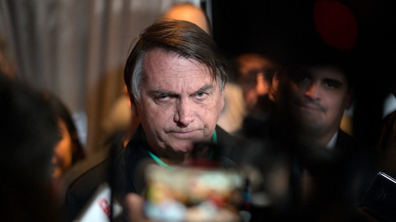 Former Brazilian President Jair Bolsonaro speaks to members of the media in Belo Horizonte, Minas Gerais state, Brazil, on June 30, 2023. Brazil's Superior Electoral Tribunal on Friday reached the majority it needs to bar far-right former president Jair Bolsonaro from politics for eight years over his unfounded claims against the voting system. (Photo by DOUGLAS MAGNO / AFP)