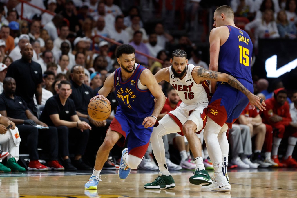 MIAMI, FLORIDA - JUNE 07: Jamal Murray #27 of the Denver Nuggets dribbles past a screen set by Nikola Jokic #15 against Caleb Martin #16 of the Miami Heat during the fourth quarter in Game Three of the 2023 NBA Finals at Kaseya Center on June 07, 2023 in Miami, Florida. NOTE TO USER: User expressly acknowledges and agrees that, by downloading and or using this photograph, User is consenting to the terms and conditions of the Getty Images License Agreement. Mike Ehrmann/Getty Images/AFP (Photo by Mike Ehrmann / GETTY IMAGES NORTH AMERICA / Getty Images via AFP)