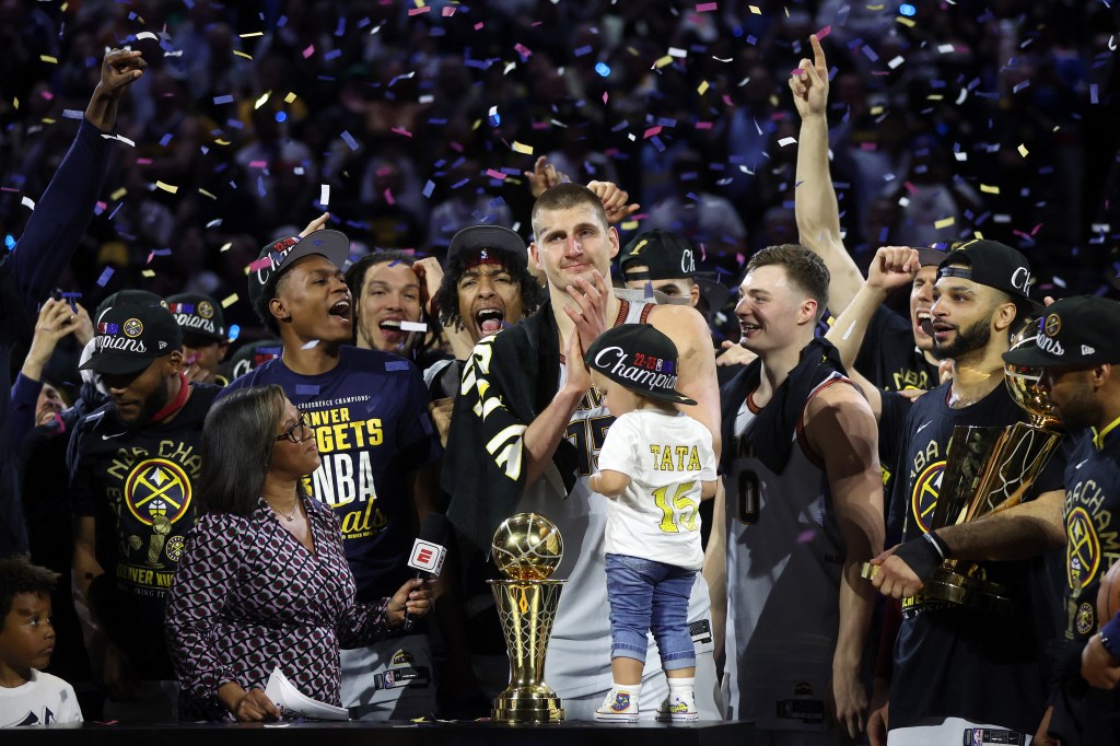 DENVER, COLORADO - JUNE 12: Nikola Jokic #15 of the Denver Nuggets celebrates with the Bill Russell NBA Finals Most Valuable Player Award after a 94-89 victory against the Miami Heat in Game Five of the 2023 NBA Finals to win the NBA Championship at Ball Arena on June 12, 2023 in Denver, Colorado. NOTE TO USER: User expressly acknowledges and agrees that, by downloading and or using this photograph, User is consenting to the terms and conditions of the Getty Images License Agreement. Matthew Stockman/Getty Images/AFP (Photo by MATTHEW STOCKMAN / GETTY IMAGES NORTH AMERICA / Getty Images via AFP)