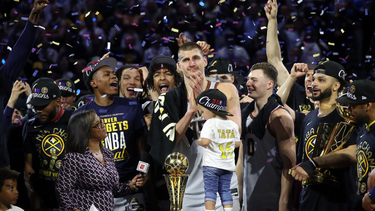 DENVER, COLORADO - JUNE 12: Nikola Jokic #15 of the Denver Nuggets celebrates with the Bill Russell NBA Finals Most Valuable Player Award after a 94-89 victory against the Miami Heat in Game Five of the 2023 NBA Finals to win the NBA Championship at Ball Arena on June 12, 2023 in Denver, Colorado. NOTE TO USER: User expressly acknowledges and agrees that, by downloading and or using this photograph, User is consenting to the terms and conditions of the Getty Images License Agreement. Matthew Stockman/Getty Images/AFP (Photo by MATTHEW STOCKMAN / GETTY IMAGES NORTH AMERICA / Getty Images via AFP)