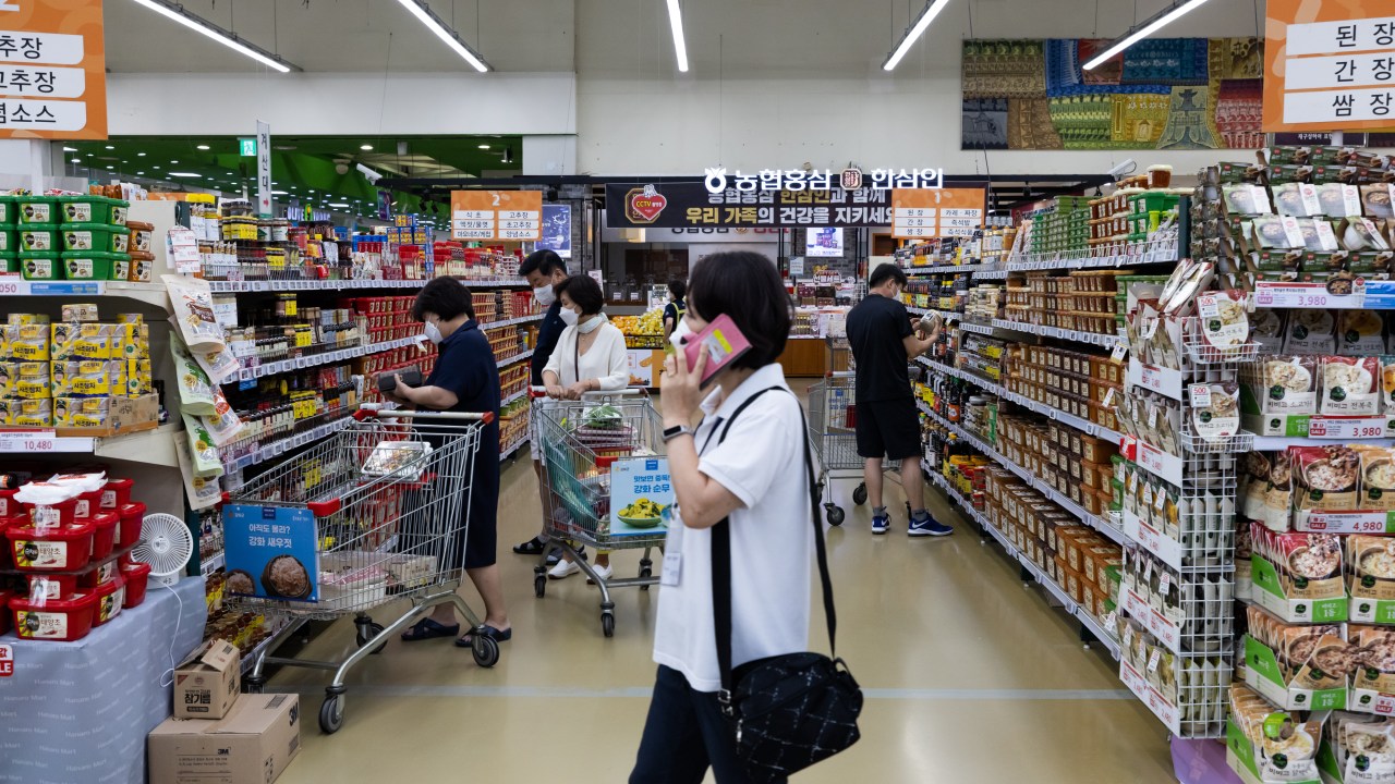 Customers wear protective masks while shopping at a Hanaro Mart supermarket, operated by the National Agricultural Cooperative Federation (Nonghyup), in the Seocho district of Seoul, South Korea, on Friday, Aug. 20, 2021. Focus is growing on whether the Bank of Korea can take the country's worst-ever virus wave in stride and tighten monetary policy on Aug. 26. Photographer: SeongJoon Cho/Bloomberg via Getty Images