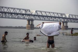 Indianos se refrescam no rio Ganges, em Patna, na Índia, durante onda de calor