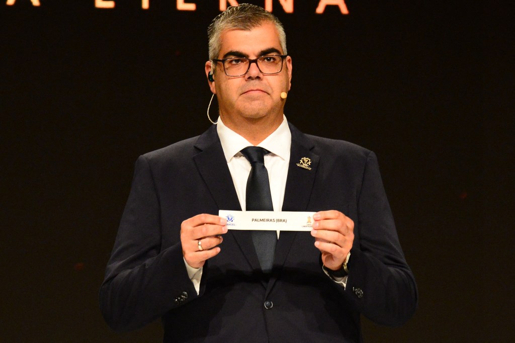 Conmebol's director of club competitions Frederico Nantes shows the slip for Brazil's Palmeiras during the draw for the round of 16 of the Copa Libertadores and Copa Sudamericana in Luque, Paraguay on July 5, 2023. (Photo by Daniel Piris / AFP)