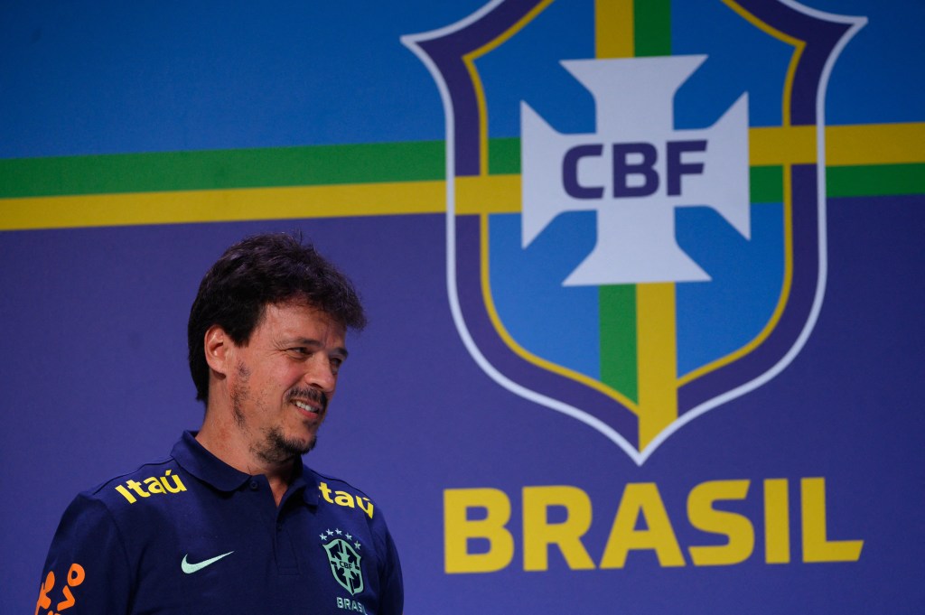 New interim head coach of the Brazilian national football team, Fernando Diniz, gestures during a press conference to present him at the Brazilian Football Confederation (CBF) headquarters in Rio de Janeiro, Brazil on July 5, 2023. Diniz, 49, was named Tuesday by the CBF as coach of the five-time world champions for a year, while Ancelotti fulfills his contract with Real Madrid, which expires at the end of June 2024. Once his relationship with the club ends, Ancelotti will assume the 'Seleção' in the 2024 Copa America, which will be played in the United States between June 20 and July 14 of that year, the President of the CBF said on Tuesday. (Photo by MAURO PIMENTEL / AFP)