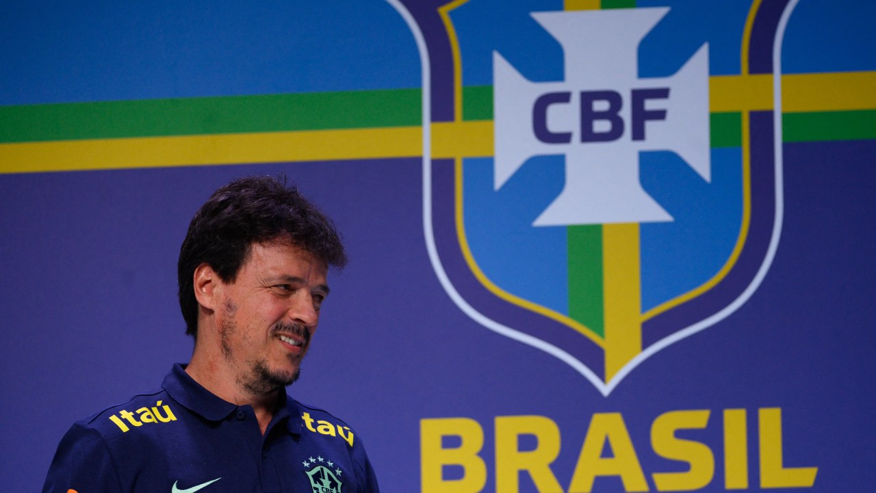 New interim head coach of the Brazilian national football team, Fernando Diniz, gestures during a press conference to present him at the Brazilian Football Confederation (CBF) headquarters in Rio de Janeiro, Brazil on July 5, 2023. Diniz, 49, was named Tuesday by the CBF as coach of the five-time world champions for a year, while Ancelotti fulfills his contract with Real Madrid, which expires at the end of June 2024. Once his relationship with the club ends, Ancelotti will assume the 'Seleção' in the 2024 Copa America, which will be played in the United States between June 20 and July 14 of that year, the President of the CBF said on Tuesday. (Photo by MAURO PIMENTEL / AFP)