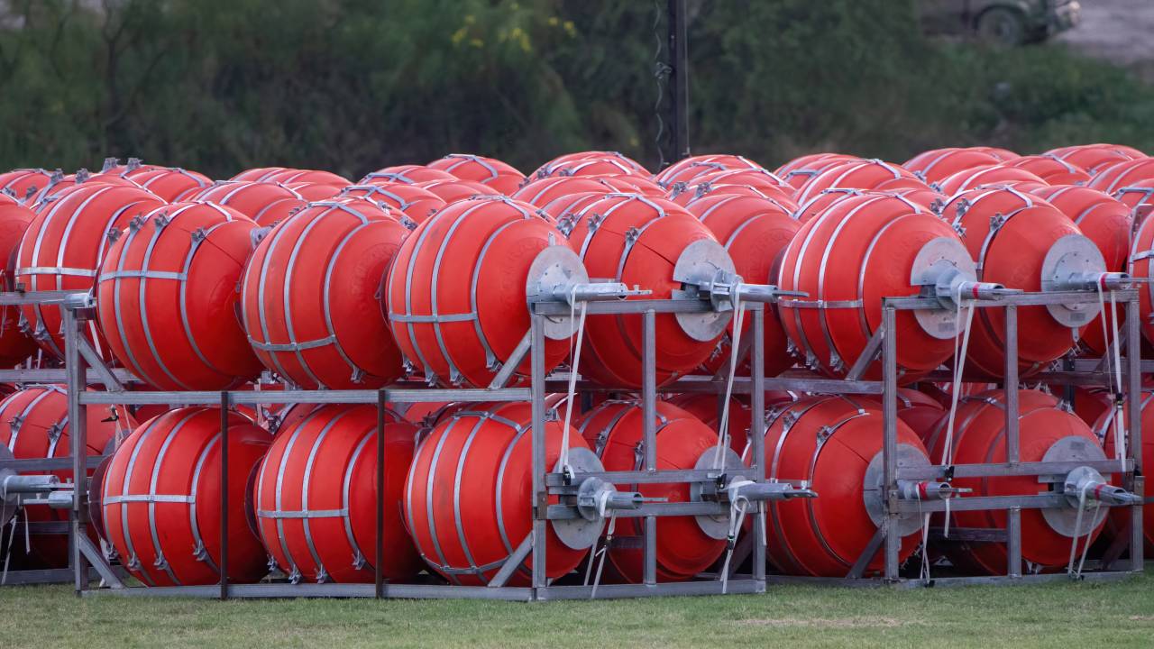 Buoy barriers prepared for installation during a water-based border operation on July 8, 2023 in Eagle Pass, Texas. A Texas businessman has filed a lawsuit in a bid to stop the state's governor from placing huge buoys in the Rio Grande to block migrants trying to cross the river, the man's lawyer said July 8."New marine barrier installation on the Rio Grande begins today," Governor Greg Abbott, a Republican, said July 7 on Twitter, in a post that included video of workers unloading huge orange buoys from flat-bed trucks. (Photo by SUZANNE CORDEIRO / AFP)