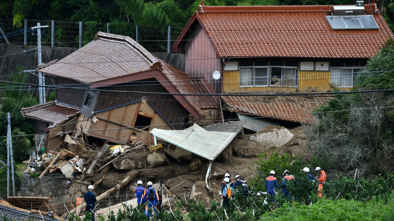 Rescue teams gather at the site of a landslide in Karatsu City, Saga prefecture, on July 11, 2023, after heavy rains hit wide areas of Kyushu island. At least two people were killed in torrential rain in southwest Japan on July 10, with fears the toll could rise, as tens of thousands of residents were told to evacuate their homes. (Photo by Kazuhiro NOGI / AFP)