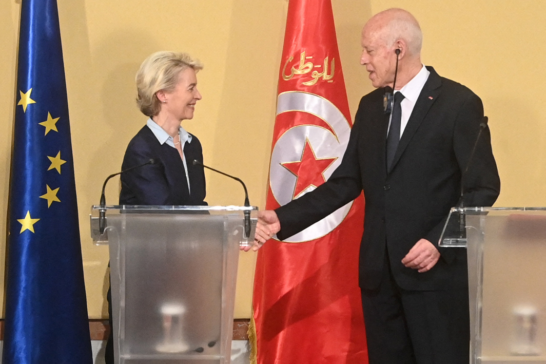 This handout picture provided by the Tunisian Presidency Press Service shows European Commission President Ursula Von der Leyen shakes the hand of Tunisia's President Kais Saied after a press briefing at the presidential palace in Tunis on July 16, 2023. The European Union and Tunisia signed on July 16, a memorandum of understanding for a "strategic and comprehensive partnership" on irregular migration, economic development and renewable energy. (Photo by Tunisian Presidency / AFP) / == RESTRICTED TO EDITORIAL USE - MANDATORY CREDIT "AFP PHOTO / HO / TUNISIAN PRESIDENCY PRESS SERVICE " - NO MARKETING NO ADVERTISING CAMPAIGNS - DISTRIBUTED AS A SERVICE TO CLIENTS ==