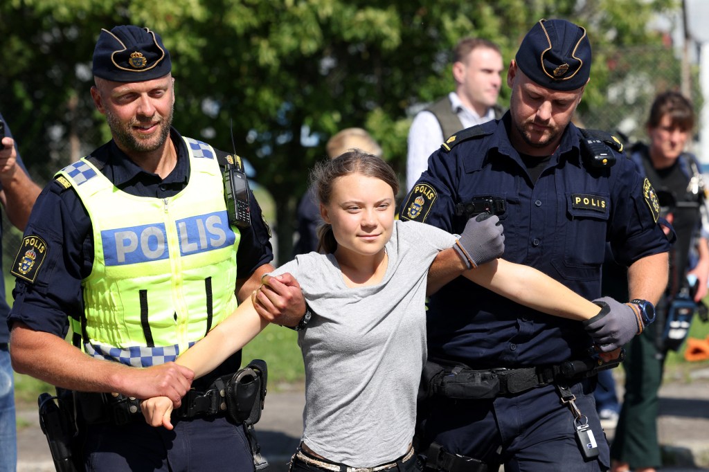 Climate activist Greta Thunberg is carried away by police officers after she took part in a new climate action in Oljehamnen in Malmo, Sweden on July 24, 2023, shortly after the city's district court convicted and sentenced her to a fine for disobeying police at a rally last month during a climate action in the Norra hamnen neighbourhood of Malmo. Thunberg was fined on Monday for disobeying police at a rally last month, but said she acted out of necessity due to the climate crisis. (Photo by Andreas HILLERGREN / TT News Agency / AFP) / Sweden OUT