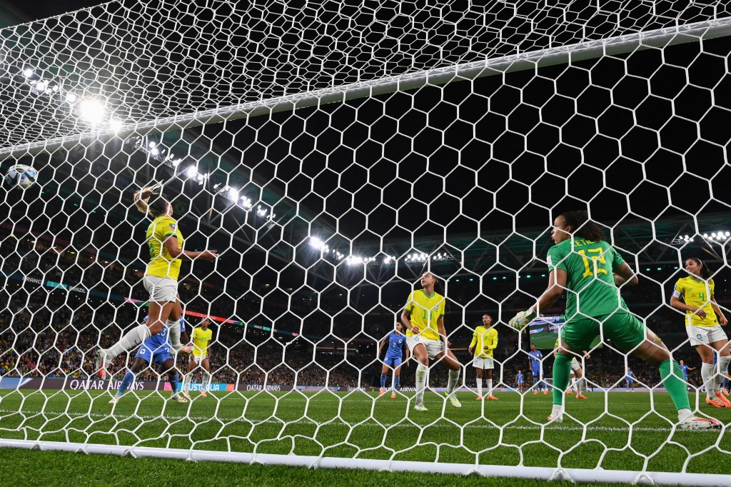 Brazil's midfielder #05 Luana Paixao (L) fails to block a shot from France's defender #03 Wendie Renard who scores her team's second goal during the Australia and New Zealand 2023 Women's World Cup Group F football match between France and Brazil at Brisbane Stadium in Brisbane on July 29, 2023. (Photo by FRANCK FIFE / AFP)