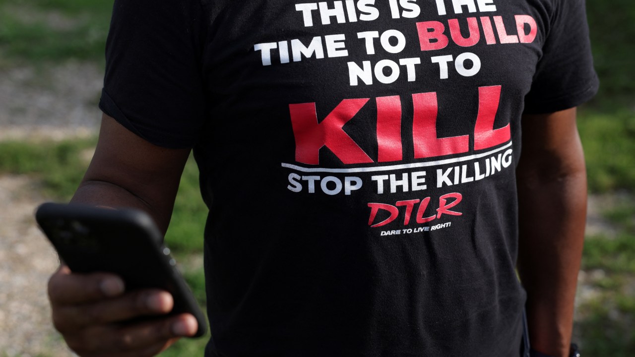 BALTIMORE, MARYLAND - JULY 03: A man wears a T-shirt calling for stopping the killing prior to a We Our Us Movement "community walk" to show support in the Brooklyn Homes neighborhood on July 3, 2023 in Baltimore, Maryland. Two people were killed and dozens injured, many of them minors, during a mass shooting at a block party in the South Baltimore neighborhood. Alex Wong/Getty Images/AFP (Photo by ALEX WONG / GETTY IMAGES NORTH AMERICA / Getty Images via AFP)