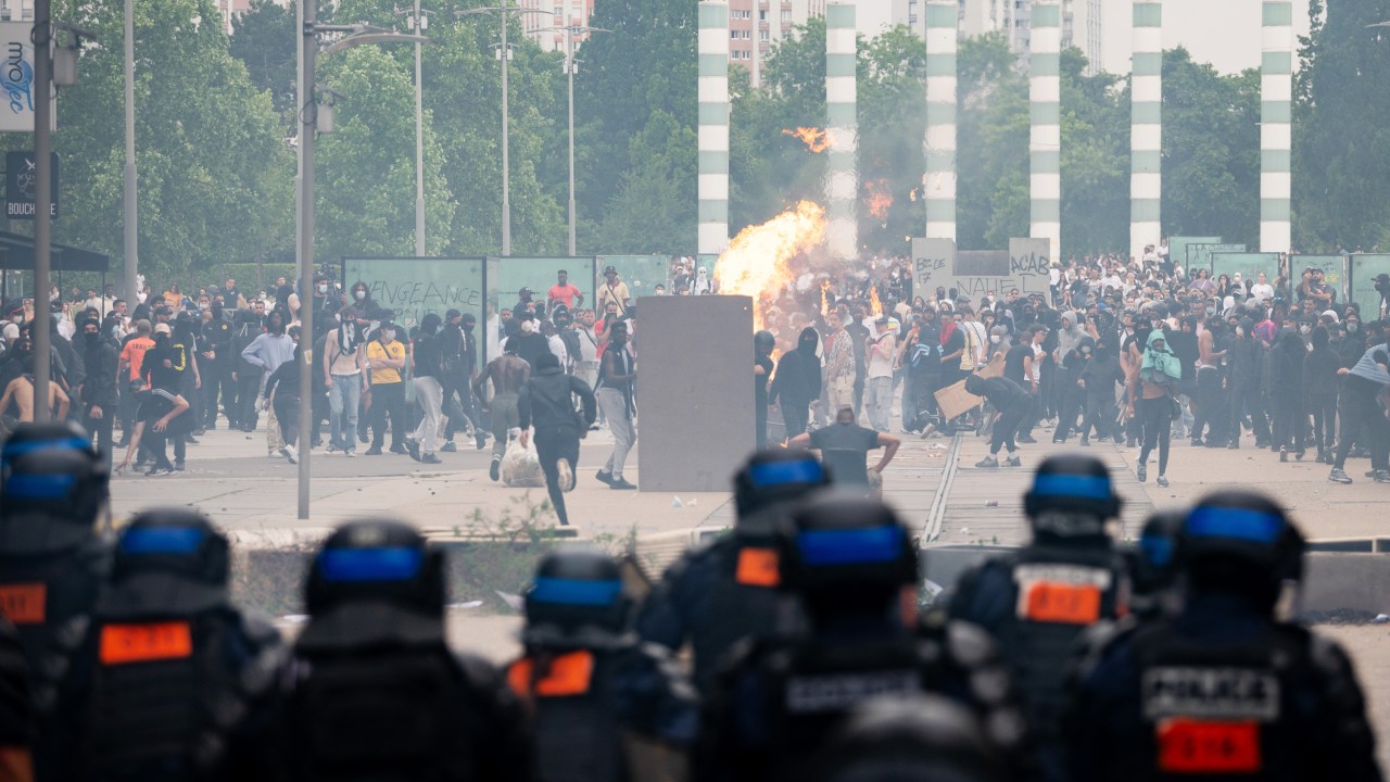Demonstrators clash with police after a march protesting the shooting of Nahel, 17, by a police officer in the Nanterre suburb of Paris, France, on Thursday, June 29, 2023. French authorities charged a police officer with murder in the shooting of a teenager earlier this week as the country braced for another night of violent clashes over the killing. Photographer: Benjamin Girette/Bloomberg via Getty Images