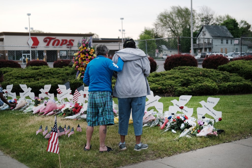 BUFFALO, NEW YORK - MAY 20: People gather at a memorial for the shooting victims outside of Tops market on May 20, 2022 in Buffalo, New York. 18-year-old Payton Gendron is accused of the mass shooting that killed 10 people at the Tops grocery store on the east side of Buffalo on May 14th and is being investigated as a hate crime. (Photo by Spencer Platt/Getty Images)