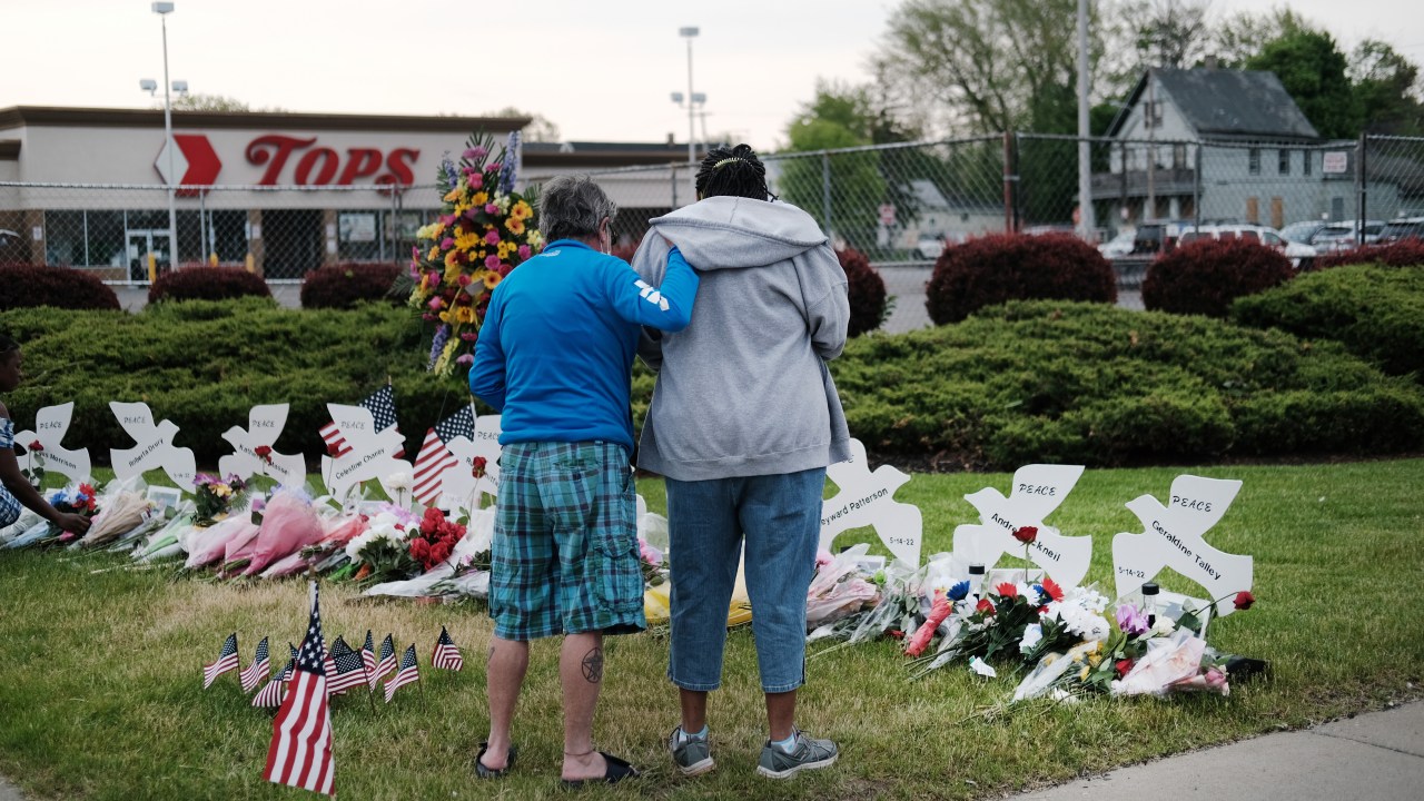 BUFFALO, NEW YORK - MAY 20: People gather at a memorial for the shooting victims outside of Tops market on May 20, 2022 in Buffalo, New York. 18-year-old Payton Gendron is accused of the mass shooting that killed 10 people at the Tops grocery store on the east side of Buffalo on May 14th and is being investigated as a hate crime. (Photo by Spencer Platt/Getty Images)