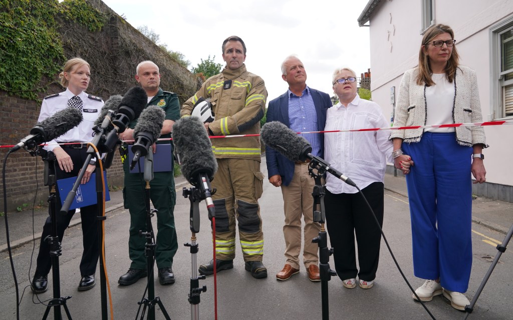 (left-right) Metropolitan Police Detective Chief Superintendent Clair Kelland, Chief Paramedic Dr John Martin from the London Ambulance Service, Andrew Pennick, London Fire Brigade and school governor John Tucker, speak to the media near the scene after a girl died and a woman in her 40s was arrested on suspicion of causing death by dangerous driving after a car crashed into a girls' prep school building in Wimbledon, south London. Officers, firefighters and paramedics, including London's Air Ambulance, responded to the incident at around 9.54am on Thursday. Picture date: Thursday July 6, 2023. (Photo by Yui Mok/PA Images via Getty Images)