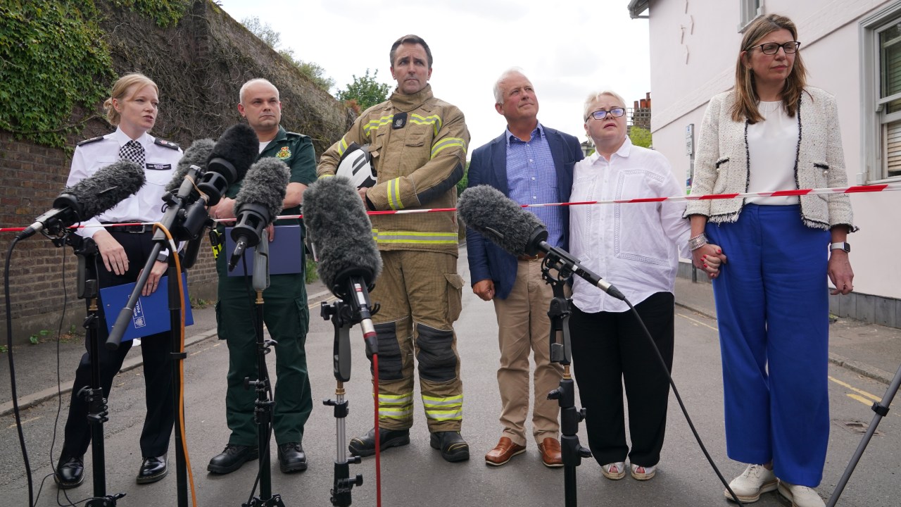 (left-right) Metropolitan Police Detective Chief Superintendent Clair Kelland, Chief Paramedic Dr John Martin from the London Ambulance Service, Andrew Pennick, London Fire Brigade and school governor John Tucker, speak to the media near the scene after a girl died and a woman in her 40s was arrested on suspicion of causing death by dangerous driving after a car crashed into a girls' prep school building in Wimbledon, south London. Officers, firefighters and paramedics, including London's Air Ambulance, responded to the incident at around 9.54am on Thursday. Picture date: Thursday July 6, 2023. (Photo by Yui Mok/PA Images via Getty Images)