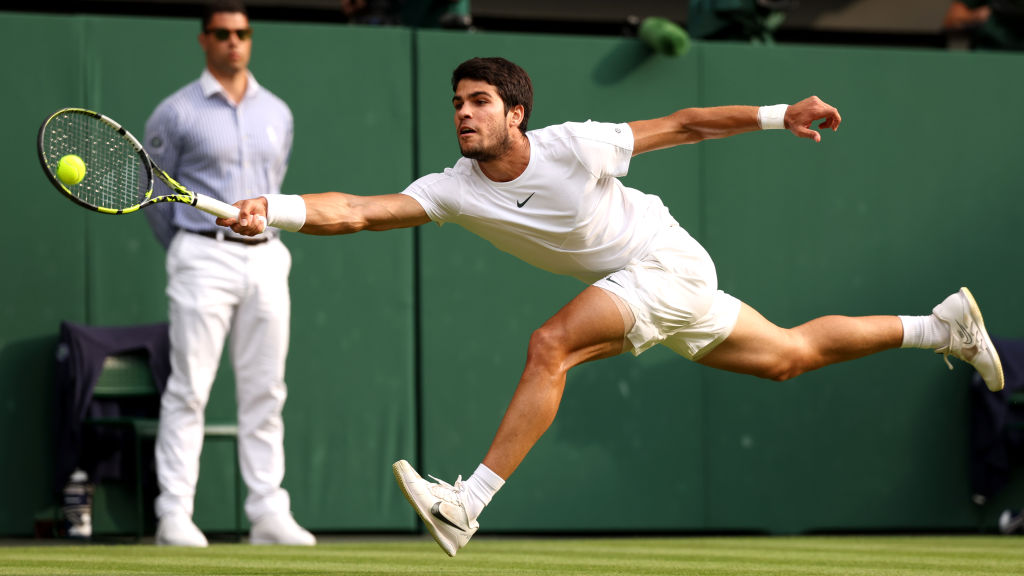 LONDON, ENGLAND - JULY 16: Carlos Alcaraz of Spain dives to play a forehand in the Men's Singles Final against Novak Djokovic of Serbia on day fourteen of The Championships Wimbledon 2023 at All England Lawn Tennis and Croquet Club on July 16, 2023 in London, England. (Photo by Julian Finney/Getty Images)
