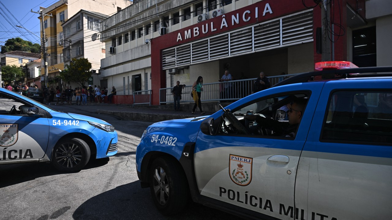 Vehicles of the Rio de Janeiro's Military Police are parked outside the Getulio Vargas hospital, where injured and dead people were admitted after a police operation at the Complexo da Penha favela complex in Rio de Janeiro, Brazil on August 2, 2023. At least nine people were killed Wednesday in a police operation targeting criminal gangs in a complex of slums in Rio de Janeiro, authorities said, the latest in a series of deadly security force raids across Brazil. The Rio raid brought the death toll from six days of police crackdowns on drug gangs in Brazil to at least 42, including 14 in Sao Paulo state and 19 in the northeastern state of Bahia. (Photo by MAURO PIMENTEL / AFP)