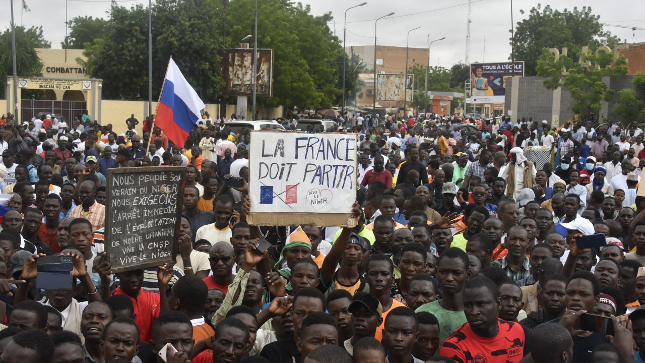 Protesters hold an anti-France placard during a demonstration on independence day in Niamey on August 3, 2023. Security concerns built on August 3, 2023 ahead of planned protests in coup-hit Niger, with France demanding safety guarantees for foreign embassies as some Western nations reduced their diplomatic presence. (Photo by AFP)