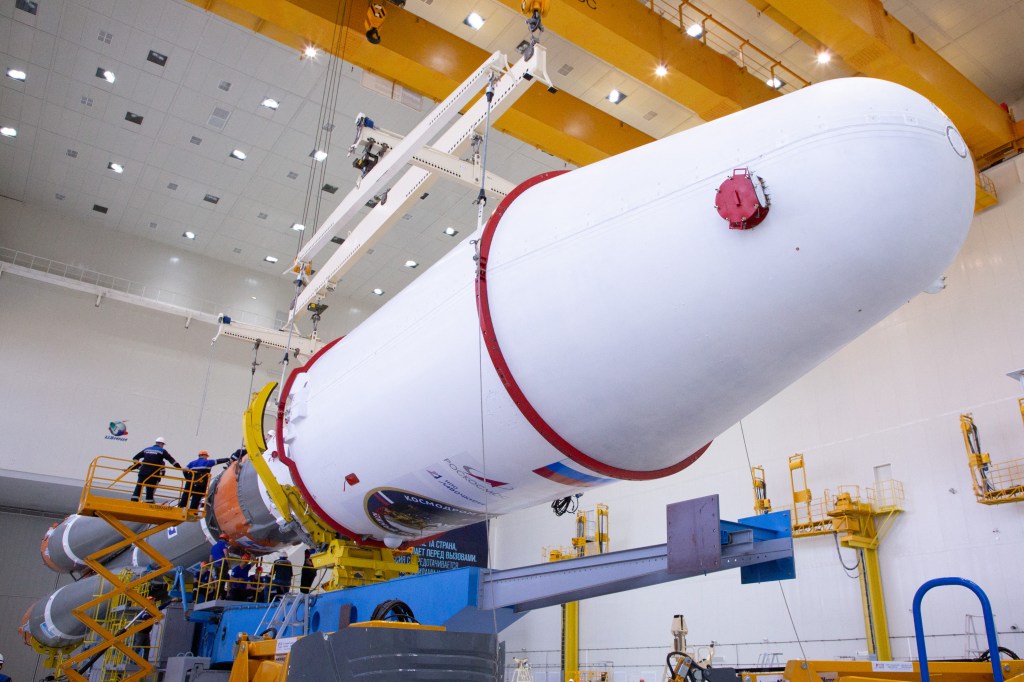 This handout photograph taken and released by the Russian Space Agency Roscosmos on August 7, 2023, shows technicians finishing to assemble a Soyuz 2.1b rocket carrying the Luna-25 lander ahead of its launch scheduled for August 11, 2023, at the Vostochny cosmodrome, some 180 km north of Blagoveschensk, in the Amur region. Russia said on August 7, 2023 it plans to launch a lunar lander later this week after multiple delays, hoping to return to the Moon for the first time in nearly fifty years. (Photo by Handout / Russian Space Agency Roscosmos / AFP) / RESTRICTED TO EDITORIAL USE - MANDATORY CREDIT "AFP PHOTO / Russian Space Agency Roscosmos / handout" - NO MARKETING NO ADVERTISING CAMPAIGNS - DISTRIBUTED AS A SERVICE TO CLIENTS