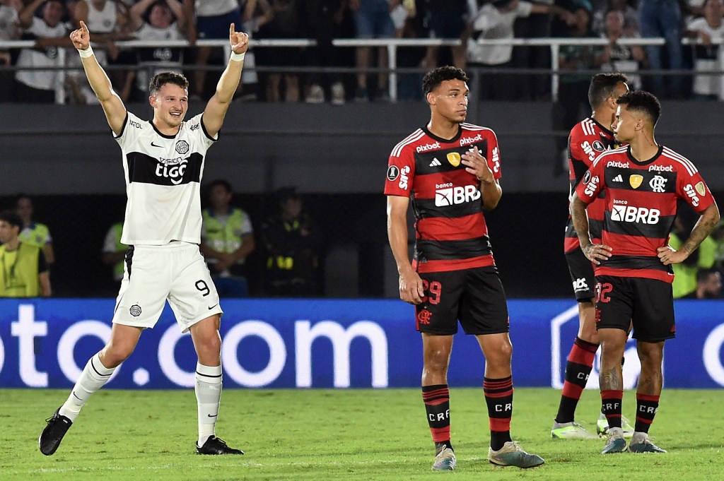 Olimpia's Argentine forward Facundo Bruera (L) celebrates after scoring during the Copa Libertadores round of 16 second leg football match between Paraguay's Olimpia and Brazil's Flamengo, at the Defensores del Chaco stadium in Asuncion, on August 10, 2023. (Photo by NORBERTO DUARTE / AFP)