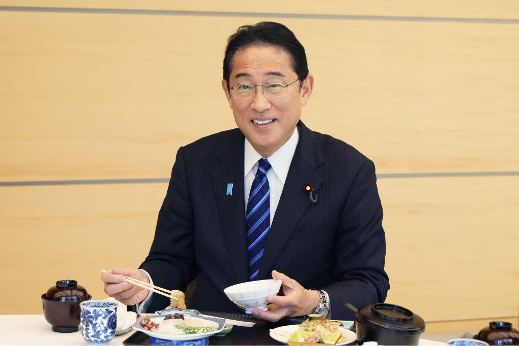 This handout photo taken and received from the Cabinet Public Relations Office via Jiji Press on August 30, 2023 shows Japan's Prime Minister Fumio Kishida posing as he eats seafood from Fukushima prefecture at the prime minister's office in Tokyo. Japan's prime minister ate what he called "safe and delicious" fish from Fukushima on August 30, days after wastewater was released from the area's crippled nuclear plant into the Pacific. (Photo by Handout / various sources / AFP) / - Japan OUT / -----EDITORS NOTE --- RESTRICTED TO EDITORIAL USE - MANDATORY CREDIT "AFP PHOTO / CABINET PUBLIC RELATIONS OFFICE via Jiji Press" - NO MARKETING - NO ADVERTISING CAMPAIGNS - DISTRIBUTED AS A SERVICE TO CLIENTS