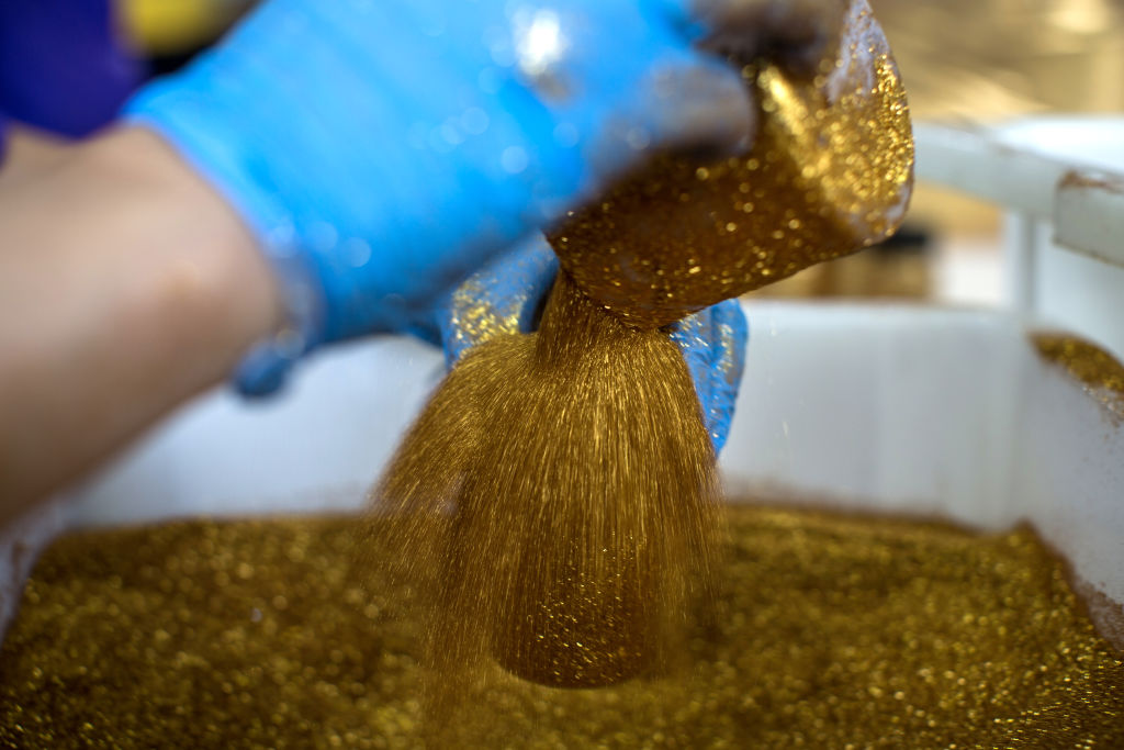 A worker fills a bottle with glitter at the Colormake Cosmetics factory in Sao Paulo, Brazil, on Friday, Feb. 21, 2020. According to Sao Paulo City Hall, the biggest city in the country will hold the largest Carnival festivities in its history, with a 38.5% increase in parade numbers and an estimated economic impact of over $523 million. Photographer: Victor Moriyama/Bloomberg via Getty Images
