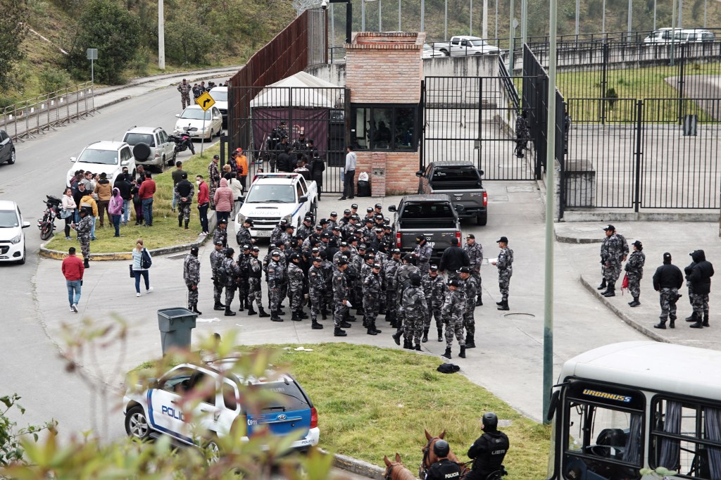 Police officers gather outside the Turi prison in Cuenca, Ecuador on September 1, 2023. Almost 60 prison guards and police officers were being held hostage Friday by inmates across Ecuador. Ecuador's SNAI prisons authority announced Thursday night that 50 prison guards and seven police officers were being held in six different prisons, without giving further details. The news came after two car bombs were detonated near buildings belonging to the prisons authority in Quito the previous evening, with no-one injured. Three grenade explosions also shook the capital. (Photo by Fernando MACHADO / AFP)
