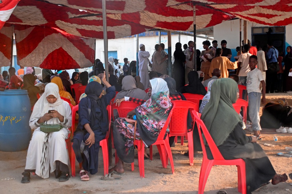 Sudanese wait outside a Passports and Immigration Services office in Port Sudan on September 3, 2023, following an announcement by the authorities of the resumption of issuing travel documents in war-torn Sudan. (Photo by AFP)