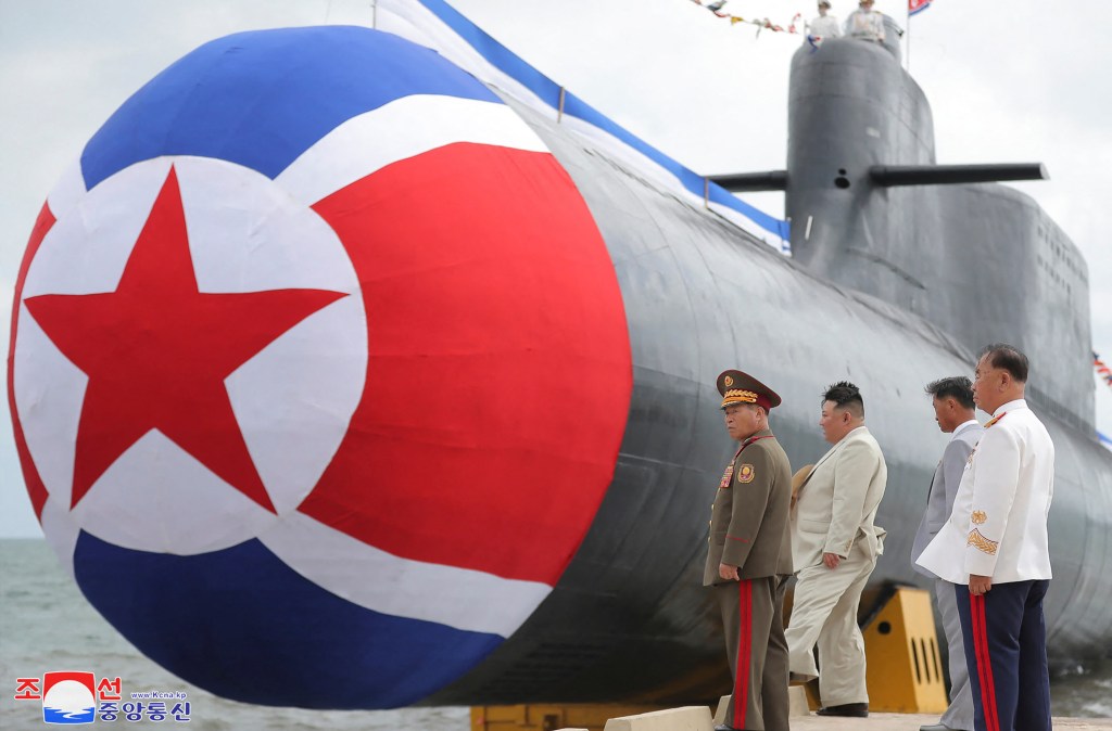 This picture taken on September 6, 2023 and released by North Korea's official Korean Central News Agency (KCNA) on September 8 shows North Korean leader Kim Jong Un (2nd L) attending the unveiling ceremony of the new submarine No. 841, named the Hero Kim Kun Ok, at an undisclosed location in North Korea. North Korea on September 8 announced it had built a "tactical nuclear attack submarine" as part of its effort to strengthen its naval force, the state news agency KCNA reported. (Photo by KCNA VIA KNS / AFP) / - South Korea OUT / ---EDITORS NOTE--- RESTRICTED TO EDITORIAL USE - MANDATORY CREDIT "AFP PHOTO/KCNA VIA KNS" - NO MARKETING NO ADVERTISING CAMPAIGNS - DISTRIBUTED AS A SERVICE TO CLIENTSTHIS PICTURE WAS MADE AVAILABLE BY A THIRD PARTY. AFP CAN NOT INDEPENDENTLY VERIFY THE AUTHENTICITY, LOCATION, DATE AND CONTENT OF THIS IMAGE. /