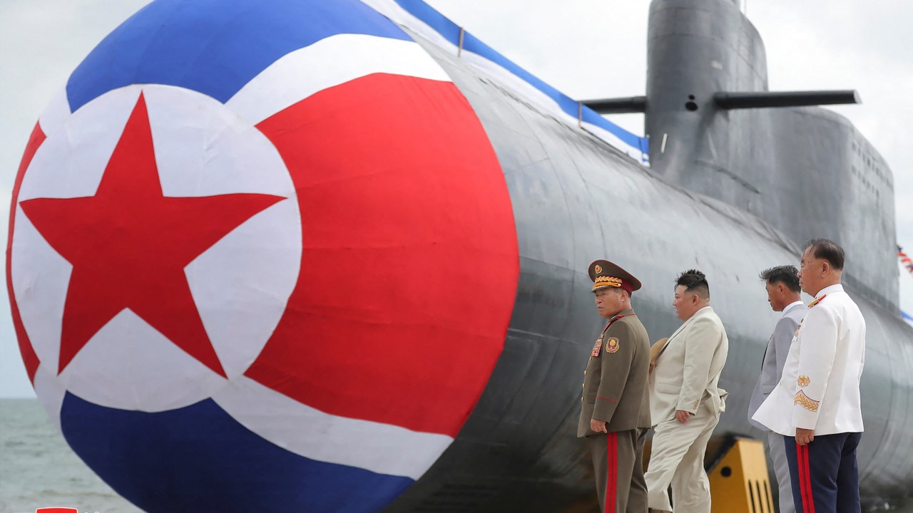 This picture taken on September 6, 2023 and released by North Korea's official Korean Central News Agency (KCNA) on September 8 shows North Korean leader Kim Jong Un (2nd L) attending the unveiling ceremony of the new submarine No. 841, named the Hero Kim Kun Ok, at an undisclosed location in North Korea. North Korea on September 8 announced it had built a "tactical nuclear attack submarine" as part of its effort to strengthen its naval force, the state news agency KCNA reported. (Photo by KCNA VIA KNS / AFP) / - South Korea OUT / ---EDITORS NOTE--- RESTRICTED TO EDITORIAL USE - MANDATORY CREDIT "AFP PHOTO/KCNA VIA KNS" - NO MARKETING NO ADVERTISING CAMPAIGNS - DISTRIBUTED AS A SERVICE TO CLIENTSTHIS PICTURE WAS MADE AVAILABLE BY A THIRD PARTY. AFP CAN NOT INDEPENDENTLY VERIFY THE AUTHENTICITY, LOCATION, DATE AND CONTENT OF THIS IMAGE. /