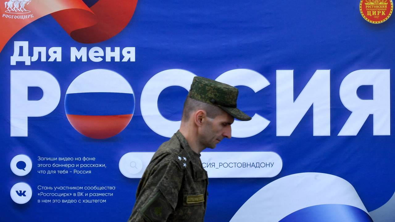 A Russian serviceman walks past a poster reading "Russia" placed in front of a circus in Southern Russian city of Rostov-on-Don on September 7, 2023, prior to Russia's local elections. Prigozhin, good or bad? In Russia, war or no war? In Rostov-on-Don, the short-lived capital of the Wagner group during its mutiny, the paradoxes and unrest within the Russian population are increased tenfold. On the flip side: everything is normal, as the Kremlin assures us. This weekend, local elections are planned in this large city located near the Ukrainian border and logistics center of the Russian army. (Photo by Olga MALTSEVA / AFP)