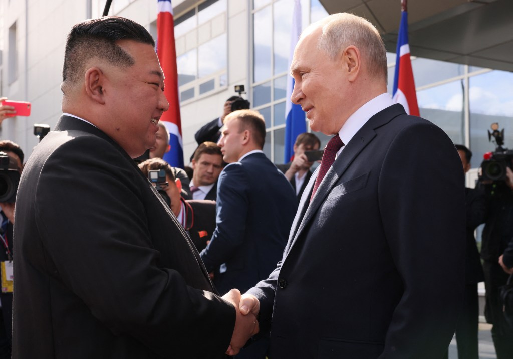 In this pool photo distributed by Sputnik agency, Russia's President Vladimir Putin (R) shakes hands with North Korea's leader Kim Jong Un (L) during their meeting at the Vostochny Cosmodrome in Amur region on September 13, 2023. Russian President Vladimir Putin and North Korean leader Kim Jong Un both arrived at the Vostochny Cosmodrome in Russia's Far East, Russian news agencies reported on September 13, ahead of planned talks that could lead to a weapons deal. (Photo by Mikhail METZEL / POOL / AFP)