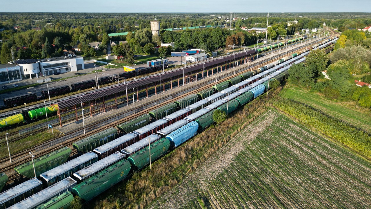This picture taken on September 20, 2023 shows trains with Ukrainian grain stored in wagons covered with white tarpaulin on the second and third tracks in Dorohusk station at the Polish-Ukrainian border. Poland's Prime Minister Mateusz Morawiecki on September 20, 2023 cautioned that the EU member would ban additional Ukrainian imports if Kyiv were to escalate their conflict over a grain embargo. (Photo by Damien SIMONART / AFP)