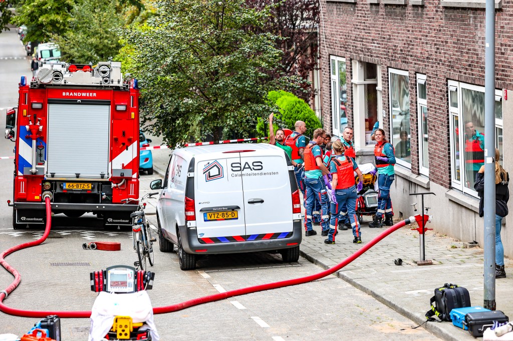Members of the fire brigade work at a fire in a building on Heiman Dullaertplein, after shootings in Rotterdam, on September 28, 2023. Twin shootings in Rotterdam on Thursday have resulted in an unknown number of fatalities, police said. A gunman dressed in combat gear opened fire in a flat in the Dutch city then burst into the Erasmus University Medical Center (Erasmus MC). Fires broke out in both places but were later extinguished. (Photo by Marco van der Caaij / ANP / AFP) / Netherlands OUT