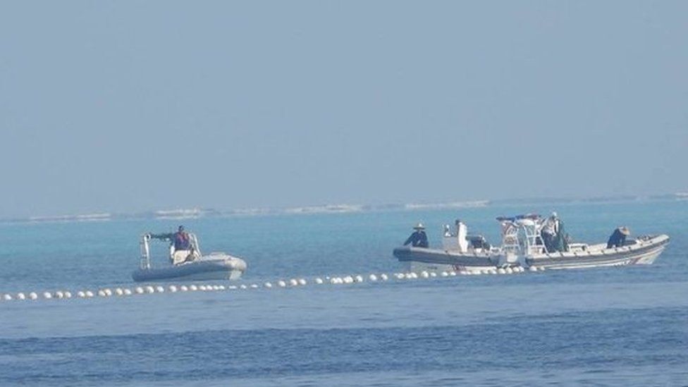 As Filipinas divulgaram imagens de uma barreira flutuante bloqueando o acesso de navios pesqueiros em Scarborough Shoal, uma ilha no Mar da China Meridional, com navios da guarda costeira chinesa nas proximidades. 24/09/2023 -