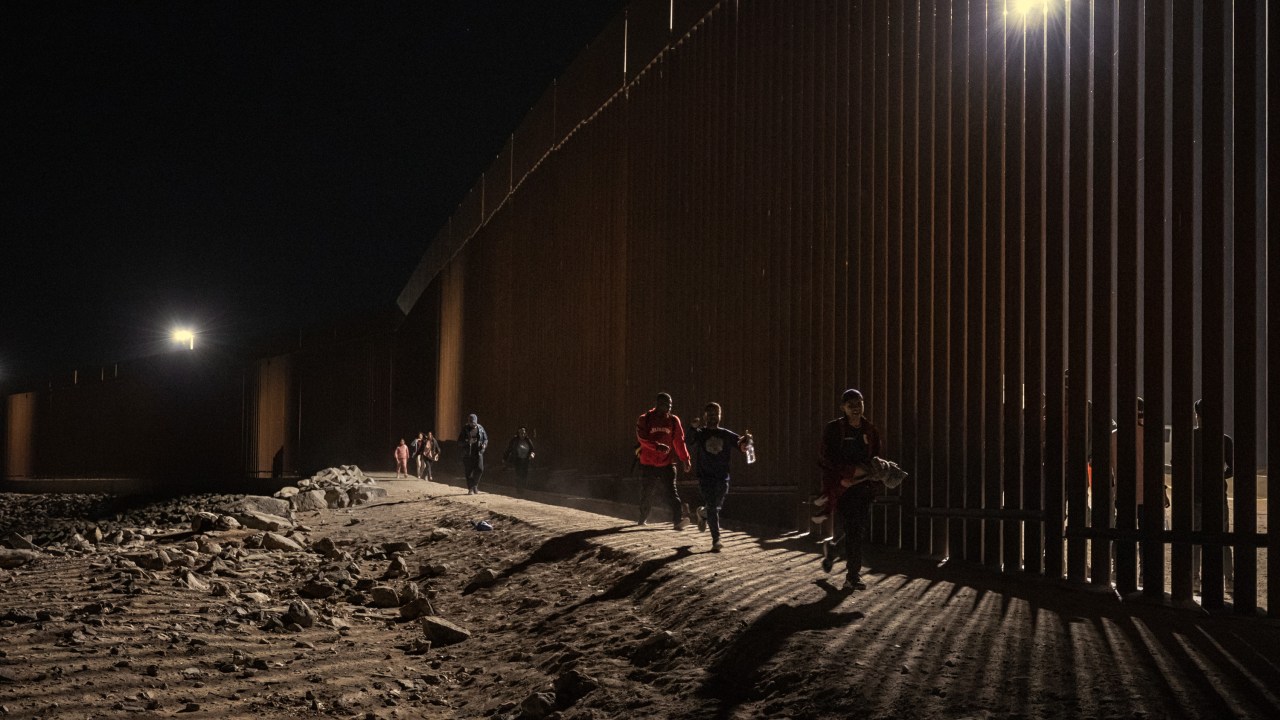 YUMA, ARIZONA - JUNE 06: Migrants walk along the U.S.-Mexico border fences on June 6, 2023 in Yuma, Arizona. Fewer migrants arrived at the border after Title 42 expired. (Photo by Qian Weizhong/VCG via Getty Images)