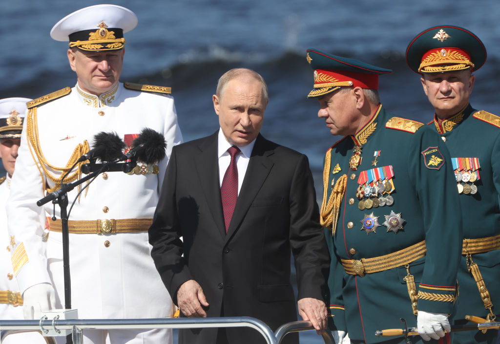SAINT PETERSBURG, RUSSIA - JULY 30: (RUSSIA OUT) Russian President Vladimir Putin (2L) talks to Defence Minister Sergey Shoigu (2L) as Navy's Commander-in-Chief Nikolai Yevmenov (L) looks on during the annual Navy Day Parade on July 30, 2023, in Saint Petersburg, Russia. President Putin and four African leaders who participated in the Russia-African Summit are watching the Naval Day Main Parade on the Neva river. (Photo by Contributor/Getty Images)
