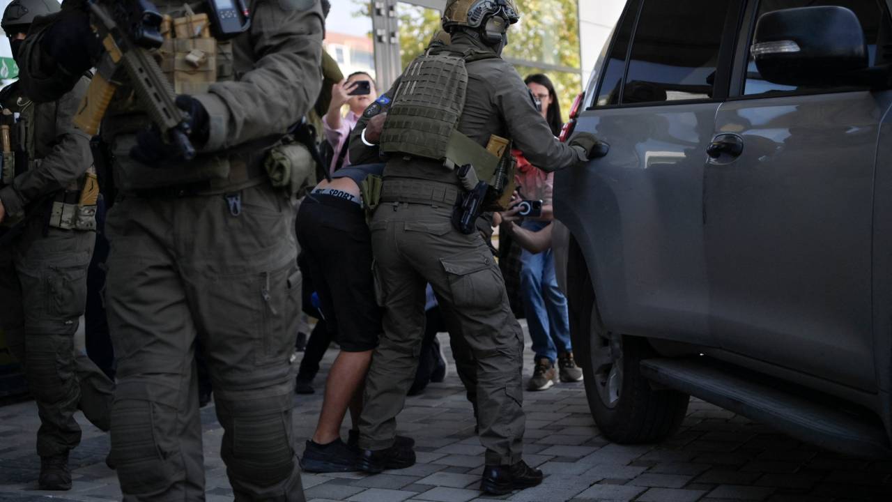 Members of the Kosovo Police Special Intervention Unit escorts one of the alleged Serbian gunmen involved in the shootings near the village of Banjska, from a court in Pristina on September 26, 2023. A standoff between gunmen and Kosovo authorities at a monastery near the Serbian border ended late September 24, 2023, the Interior Minister in Pristina announced, after police regained control of the area. A police patrol was ambushed near the village of Banjska earliar in the day, leaving one Kosovo law enforcement officer dead and another wounded, after which the gunmen fled to a nearby monastery where they barricaded themselves and traded gunfire with Kosovo police for hours. (Photo by Armend NIMANI / AFP)