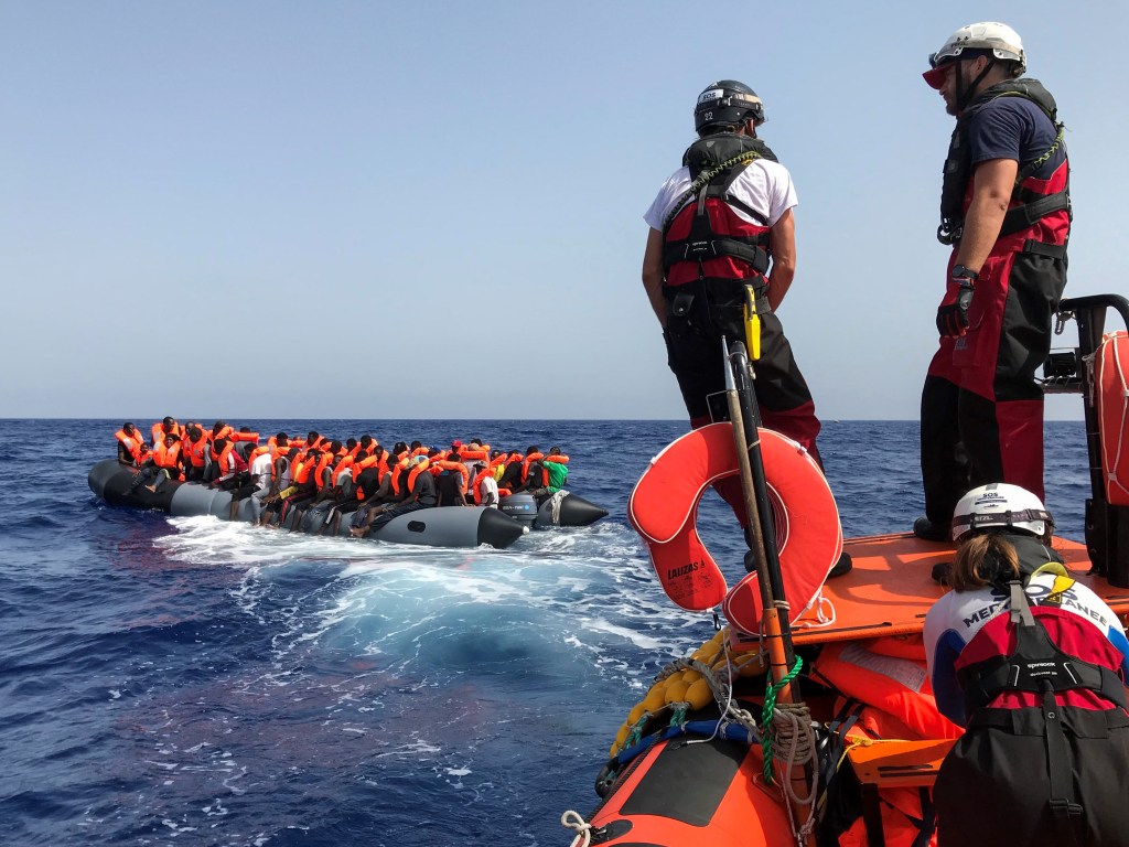 (FILES) Crew members of the 'Ocean Viking' rescue ship, operated by French NGOs SOS Mediterranee and Medecins sans Frontieres (MSF), stand ready on board of a "rhib", an inflatable dinghy, as they approach an inflatable boat carrying some 85 migrants on August 9, 2019, during a rescue operation in the Mediterranean Sea. European maritime rescue organisation SOS Mediterranee was on September 28, 2023 awarded the Right Livelihood prize for its life-saving migrant rescue operations in "the world's deadliest migration route". (Photo by Anne CHAON / AFP)