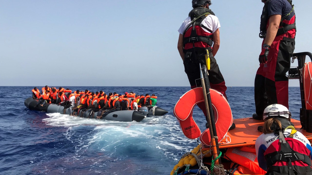 (FILES) Crew members of the 'Ocean Viking' rescue ship, operated by French NGOs SOS Mediterranee and Medecins sans Frontieres (MSF), stand ready on board of a "rhib", an inflatable dinghy, as they approach an inflatable boat carrying some 85 migrants on August 9, 2019, during a rescue operation in the Mediterranean Sea. European maritime rescue organisation SOS Mediterranee was on September 28, 2023 awarded the Right Livelihood prize for its life-saving migrant rescue operations in "the world's deadliest migration route". (Photo by Anne CHAON / AFP)