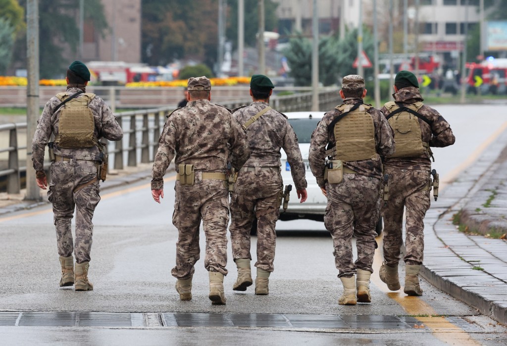 TOPSHOT - Members of Turkish Police Special Forces secure the area near the Interior Ministry following a bomb attack in Ankara, on October 1, 2023, leaving two police officers injured. The interior ministry said on October 1, 2023, that two attackers arrived in a commercial vehicle around 9:30 am (0630 GMT) "in front of the entrance gate of the General Directorate of Security of our Ministry of the Interior, and carried out a bomb attack." (Photo by Adem ALTAN / AFP)