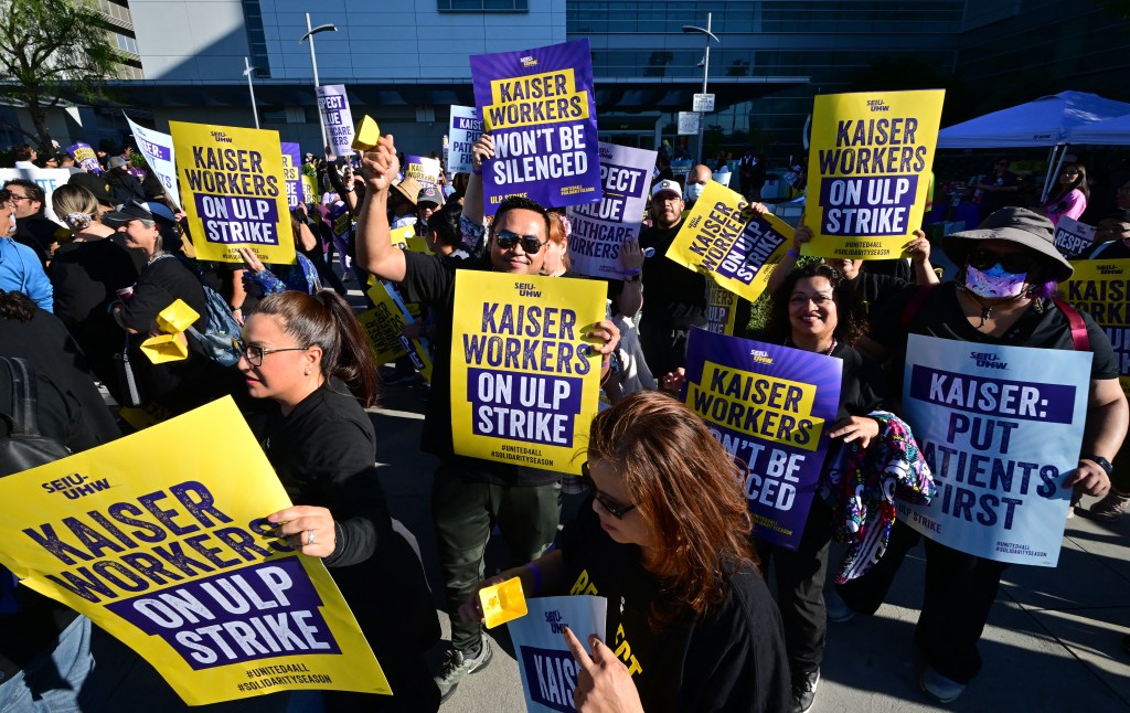 Kaiser Permanente employees, joined by Union members representing the workers, walk the picket line in Los Angeles, California on October 4, 2023. More than 75,000 employees at Kaiser Permanente began one of the largest healthcare worker strikes in recent US history on Wednesday after failing to resolve a dispute over staffing levels. (Photo by Frederic J. BROWN / AFP)