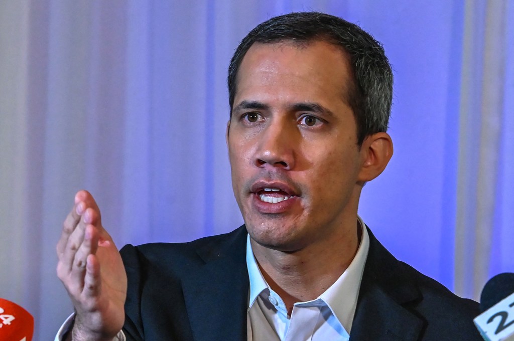 (FILES) Venezuelan opposition politician Juan Guaido speaks to the press in Miami, Florida, on April 27, 2023. The Venezuelan prosecutor's office said it had issued an arrest warrant for opposition leader Juan Guaido and would ask for Interpol's help in his apprehension, on October 5, 2023. Prosecutors were appointed "to issue an arrest warrant against him and to request a Red Notice from Interpol so that he pays for his crimes," Prosecutor Tarek William Saab said. Living in exile in the United States, Guaido was accused of treason, usurpation of functions, money laundering and association with a view to committing a crime, the official said. (Photo by Giorgio Viera / AFP)
