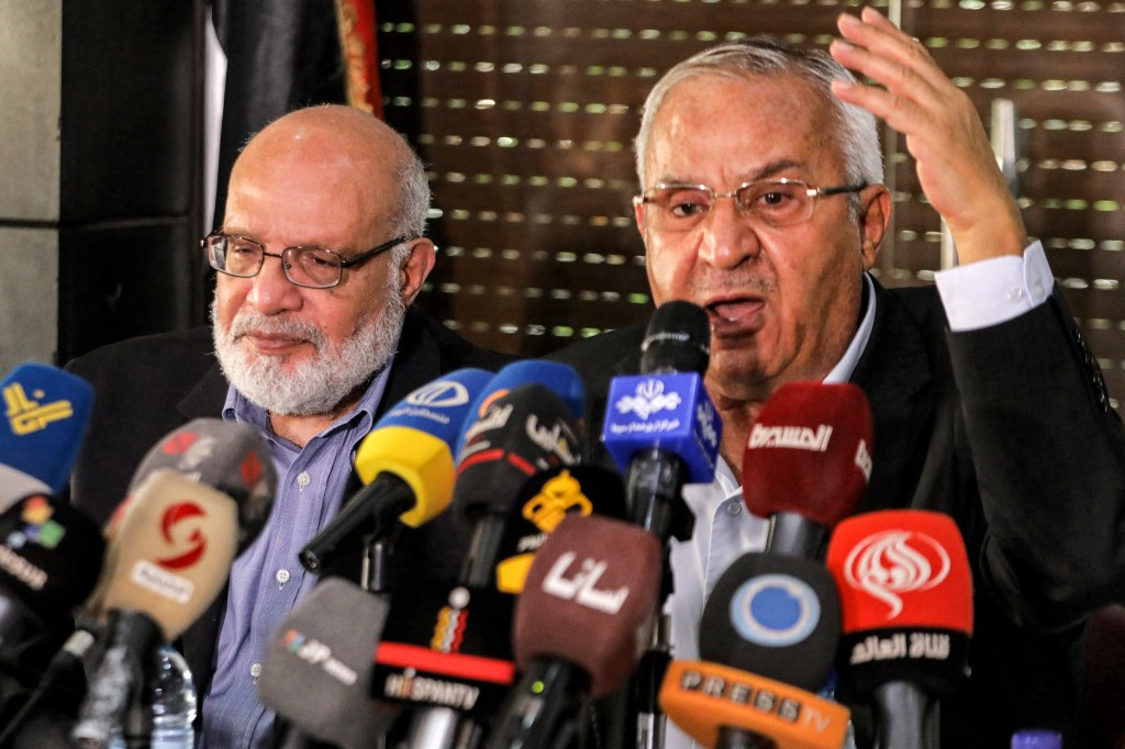 Talal Naji (R), secretary-general of the Popular Front for the Liberation of Palestine-General Command (PFLP-GC) speaks while seated next to Abdulaziz al-Minawi, senior official of the Palestinian Islamic Jihad movement, during a meeting of the Palestinian faction leaders in Damascus on October 11, 2023. Israel declared war on Hamas on October 8 following a shock land, air and sea assault by the Gaza-based Islamists. The death toll from the shock cross-border assault by Hamas militants rose to 1,200, making it the deadliest attack in the country's 75-year history, while Gaza officials reported more than 900 people killed as Israel pounded the territory with air strikes. (Photo by LOUAI BESHARA / AFP)