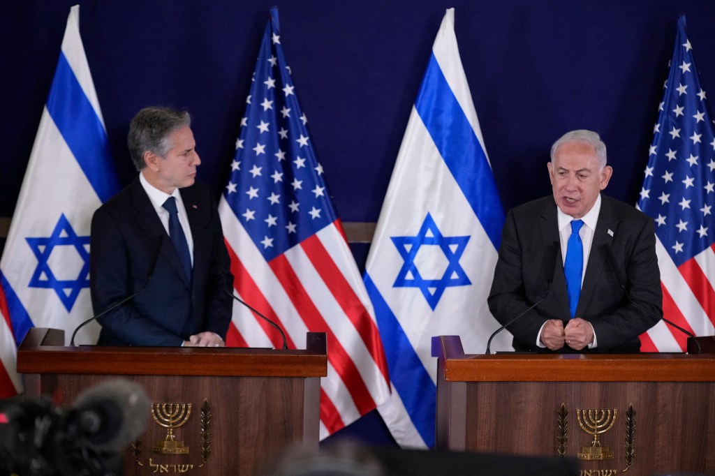 US Secretary of State Antony Blinken (L) looks on as Israeli Prime Minister Benjamin Netanyahu gives statements to the media inside The Kirya, which houses the Israeli Defence Ministry, after their meeting in Tel Aviv on October 12, 2023. Blinken arrived in a show of solidarity after Hamas's surprise weekend onslaught in Israel, an AFP correspondent travelling with him reported. He is expected to visit Israeli Prime Minister Benjamin Netanyahu as Washington closes ranks with its ally that has launched a withering air campaign against Hamas militants in the Gaza Strip. (Photo by Jacquelyn Martin / POOL / AFP)