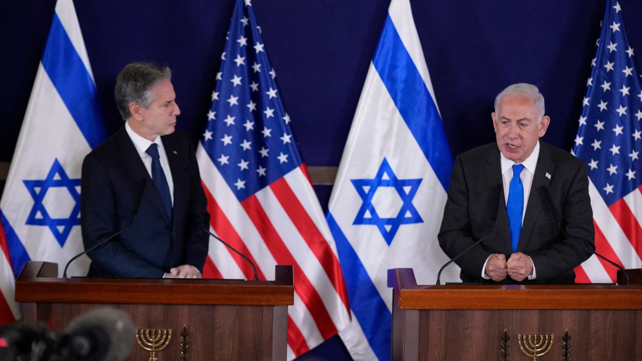US Secretary of State Antony Blinken (L) looks on as Israeli Prime Minister Benjamin Netanyahu gives statements to the media inside The Kirya, which houses the Israeli Defence Ministry, after their meeting in Tel Aviv on October 12, 2023. Blinken arrived in a show of solidarity after Hamas's surprise weekend onslaught in Israel, an AFP correspondent travelling with him reported. He is expected to visit Israeli Prime Minister Benjamin Netanyahu as Washington closes ranks with its ally that has launched a withering air campaign against Hamas militants in the Gaza Strip. (Photo by Jacquelyn Martin / POOL / AFP)